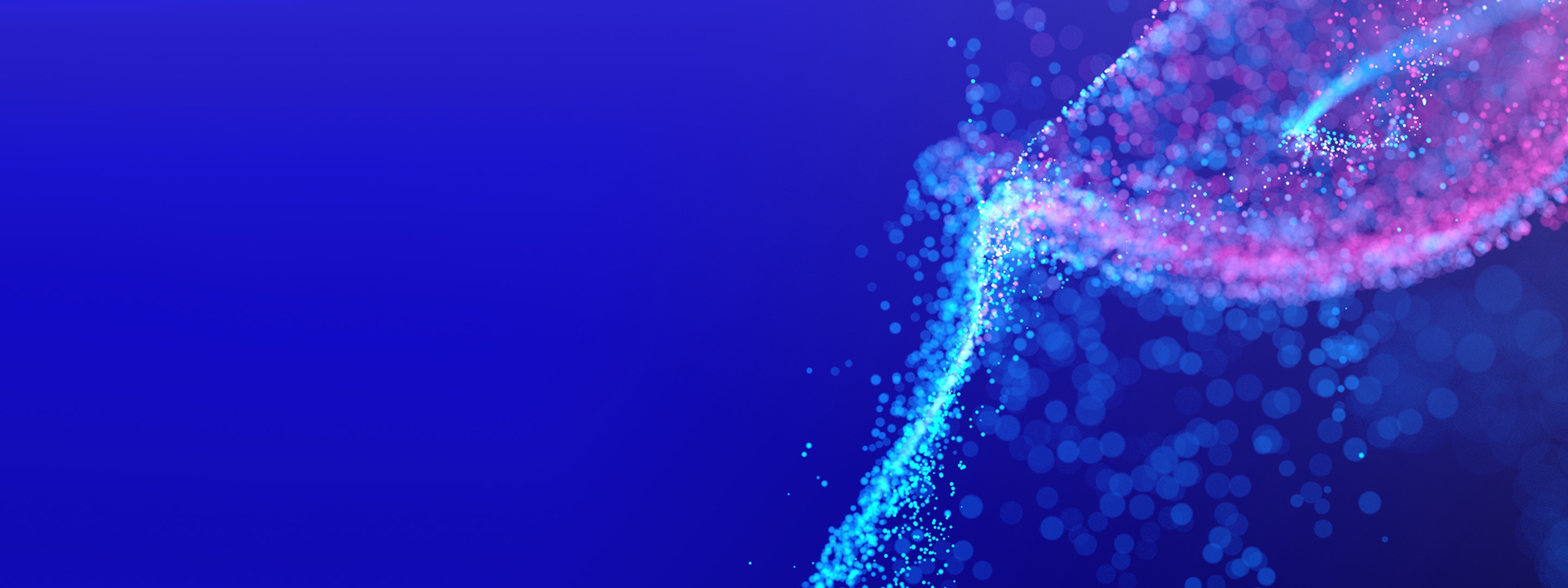Blue, purple, and pink particles shown on an electric blue background